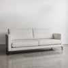 angled view of the corcovado drift sofa with black metal legs and two oversized back and seat cushions