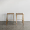 tan leather bar stool shown as a set of two