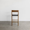 back view of the savanna bar stool with vintage brown wood and black leather seat from Corcovado