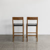 back view of two of the savanna bar stools with vintage brown wood and black leather seat from Corcovado