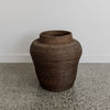 close up of the round african basket with a vintage brown finish