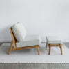 close up of a armless chair and footstool in cream fabric