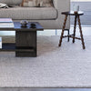 photo of the omaha pebble rug in a living room with sofa and side table