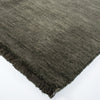 close up of the forest green wool floor rug with small fringing detail from corcovado