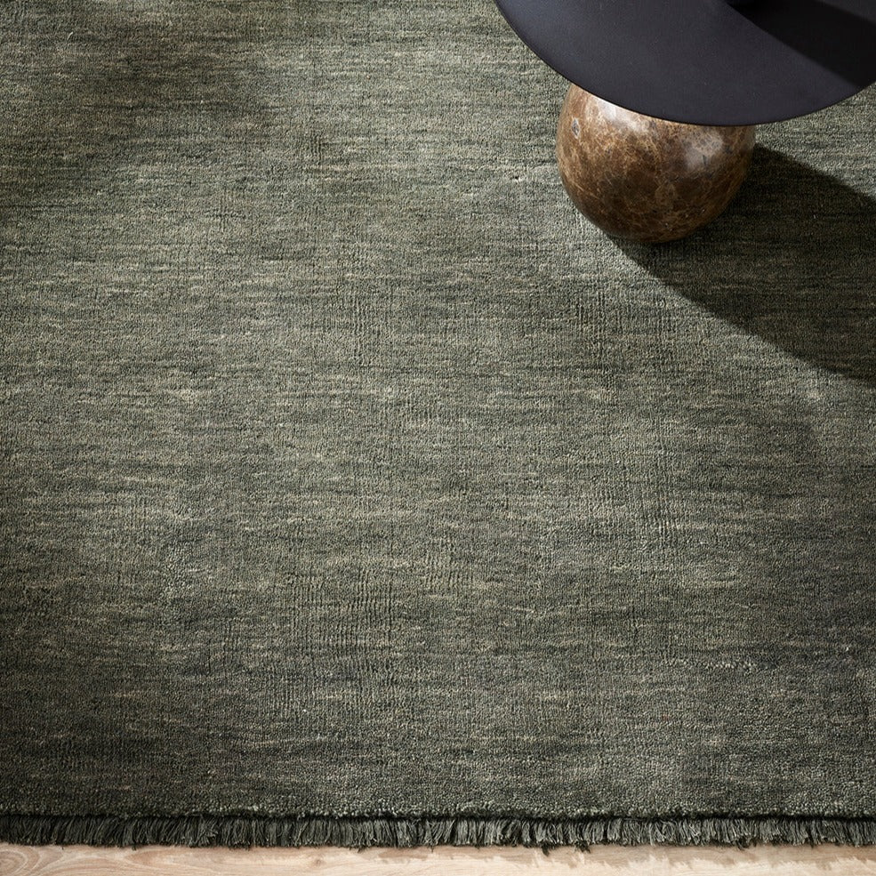 forest green wool floor rug with small fringing detail from corcovado